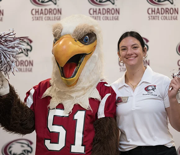 Eagle mascot and student smiling