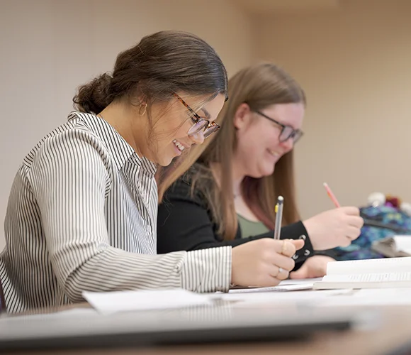 Two students working on papers