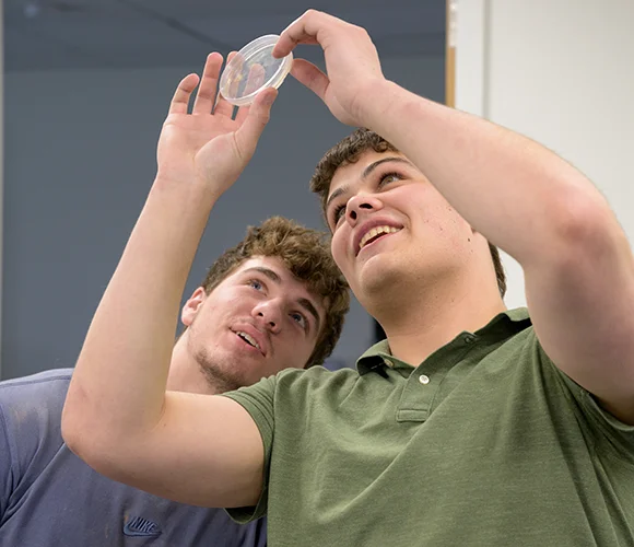 Two science students examining a sample