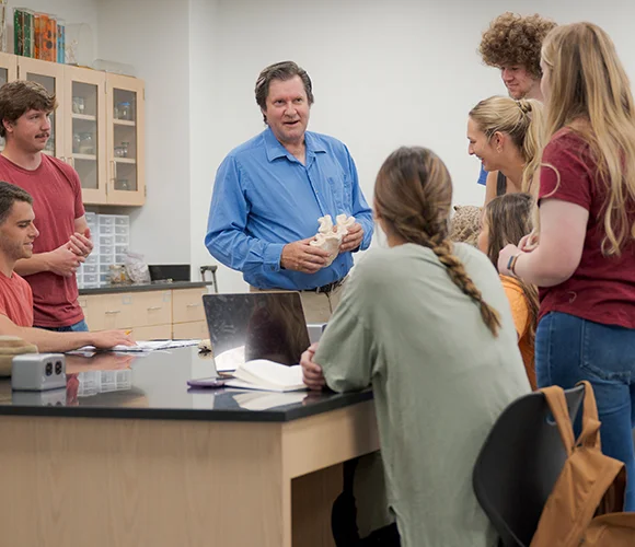 Science professor speaking to a group of students