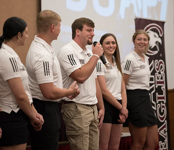 Several students speaking to an audience