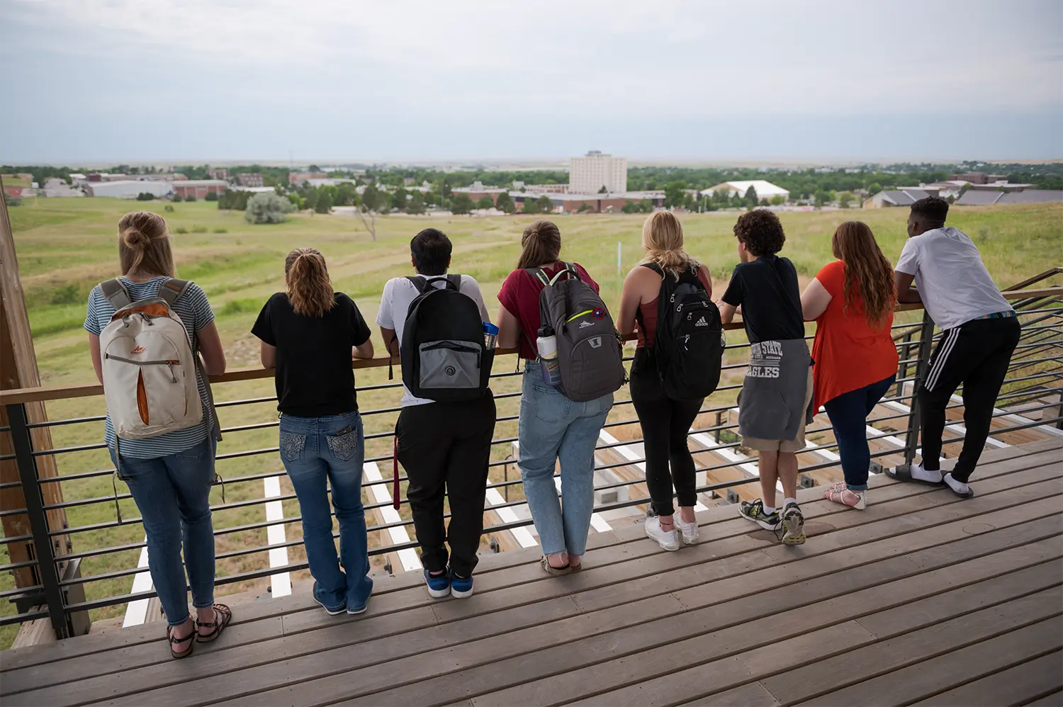 A group of students looking over a railing at the Rangeland Complex