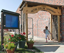 A child enters the outdoor play area at the Child Development Center