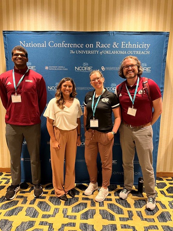 Porter Anderson, Jennifer Stadler, Britt Helmbrecht, and Alex Helmbrecht pose during the National Conference on Race and Ethnicity (NCORE) at the Hilton New Orleans Riverside Hotel in New Orleans, Louisiana, June 2, 2023.