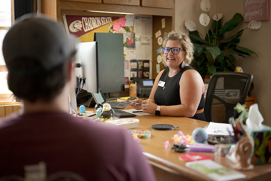 An advisor works with a student