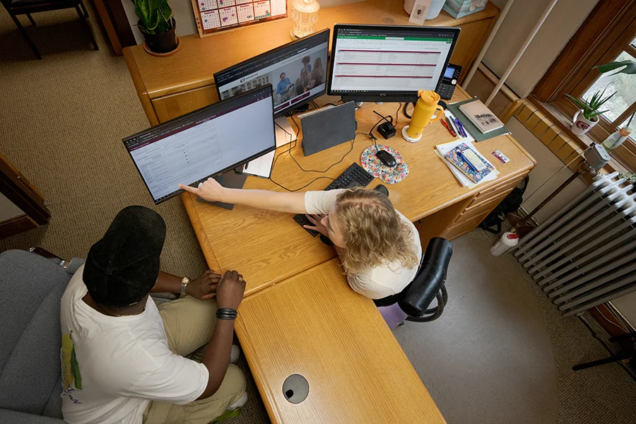 An advisor works with a student