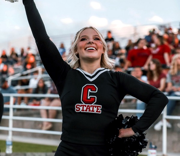 A cheerleader cheering at a CSC football game