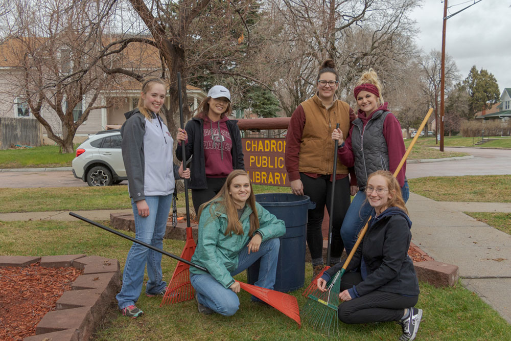 Volunteers for The Big Event pose with their gardening equipment at the Chadron Public Library