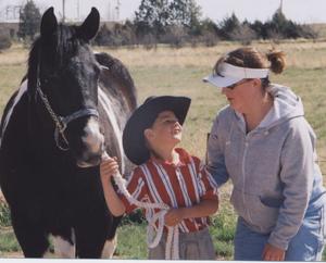 Chadron State Ag Club member Ann McElroy of Gurley chats with one of the contestants in the recent Round Robin Showmanship Contest at CSC. The young showman is Steven Watson of Whitney.