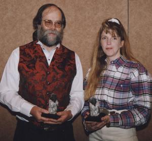 Dr. Chuck Butterfield and Dr. Georgia Younglove hold the Penguin Awards they received as the outstanding scholar and teacher, respectively, in the School of Professional and Graduate Studies.