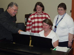 Musicians learning new music at piano