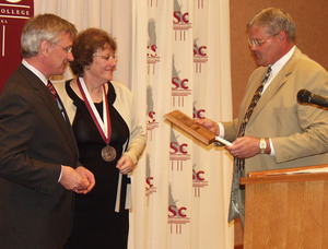 Former state senators Bob Wickersham and Sandra Scofield accept Distinguished Service Awards from Chadron State College President Dr. Tom Krepel. The awards were presented Sunday night during a special ceremony at the CSC Student Center.