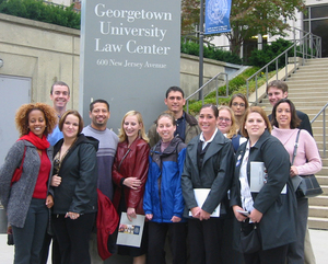 Large group of students pose for a photo at Georgetown Law Center