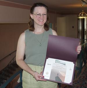 Christina Hill displays the certificate she won for first place.