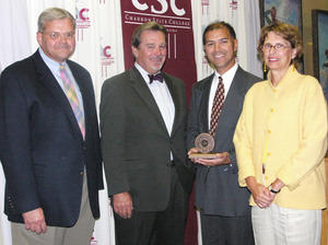 Dr. Robert Stack displays the Teacher of the Year award. Also pictured, from left, are Chadron State President Tom Krepel, Nebraska State College System Executive Director Stan Carpenter and Willa Kosman, NSC Board of Trustees member.