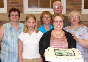 Christina Augustine holds the cake at her graduation reception.