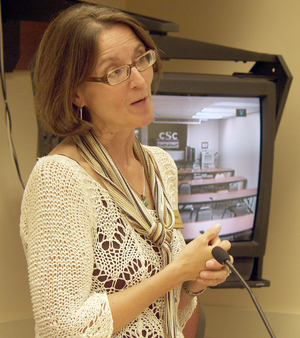 Pat Hoffman demonstrates the college's interactive television system.