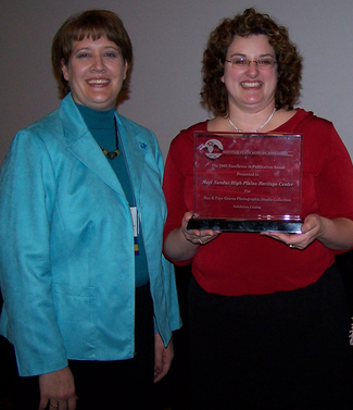 Sarah Polak displays the publication award received from the Mountain Plains Museum Association.