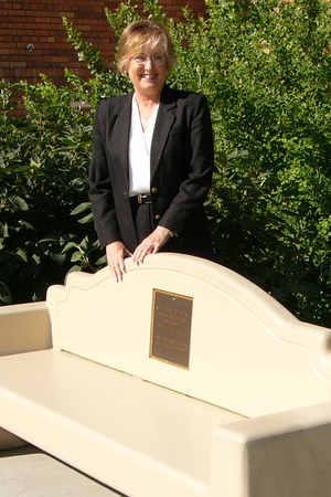 Janie Park poses with a bench on the CSC campus.