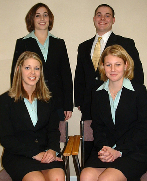 Four students pose in professional attire