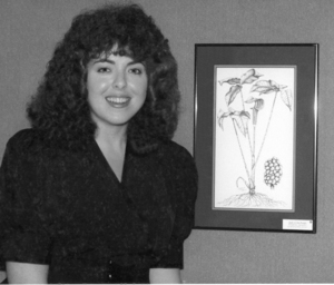 Bellamy Parks Jansen poses alongside one of the nearly 50 large botanical illustrations.