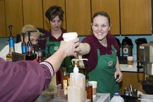 Maya Alcorn hands a sugar-free caramel latte to a patron.