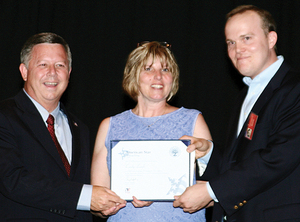 Gov. Dave Heineman and Bill Knudsen flank Cindy Lanik.