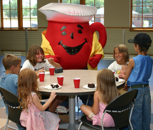 Kool-Aid Man joins children for cake and Kool-Aid, at the Sandoz Center.