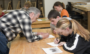 Don Ruleaux demonstrates silver point drawing for Dayne Reddy.