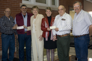 Elks members Lawrence Olson, Gil Nitsch, Jim Claussen and Von Bartlett present checks of $60,000 and $30,000 to Chadron State College