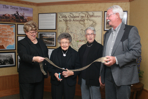 Lois Veath, Virginia Coffee, Barb Marcy and Ron Hunter get ready to cut the ribbon for the new C.F. Coffee Gallery.