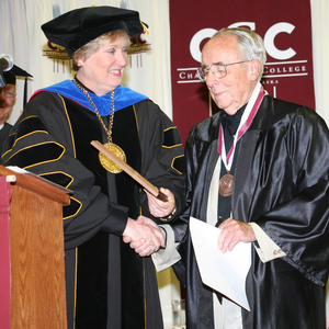 Keith Blackledge of North Platte receives a Distinguished Service Award medallion and plaque from Dr. Janie Park.