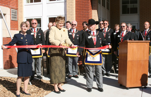 Chadron State President Janie Park cuts the ribbon during Sunday's dedication ceremony.