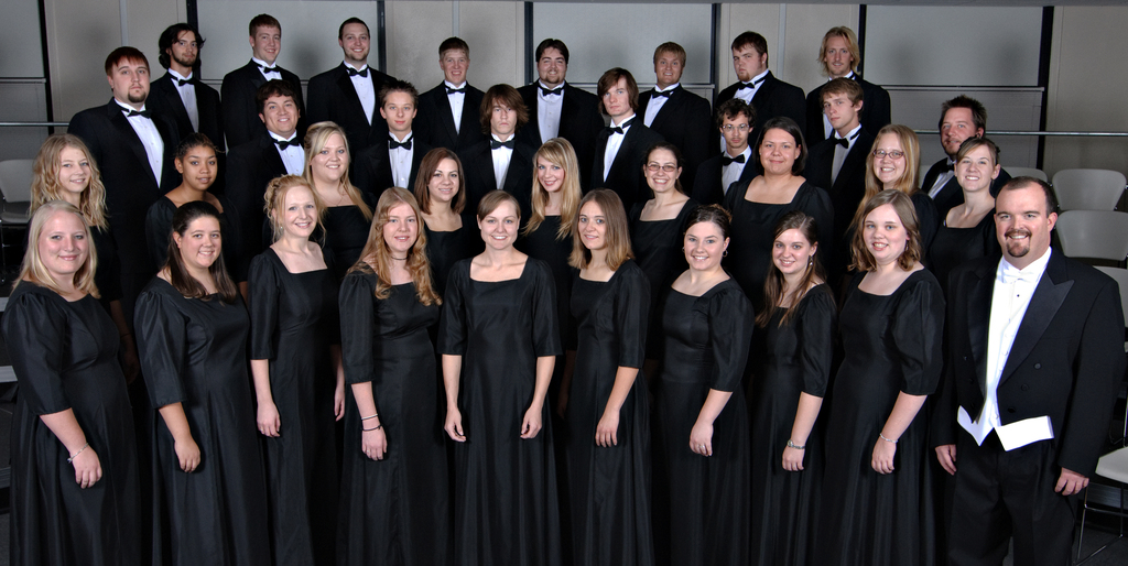 Choir students pose onstage