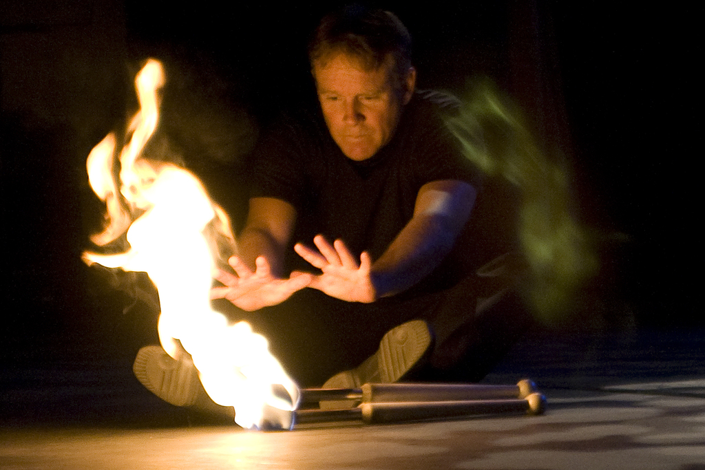 Man puts hands close to fire