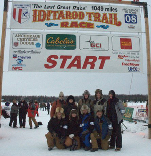 Students pose under Iditarod Trail sign