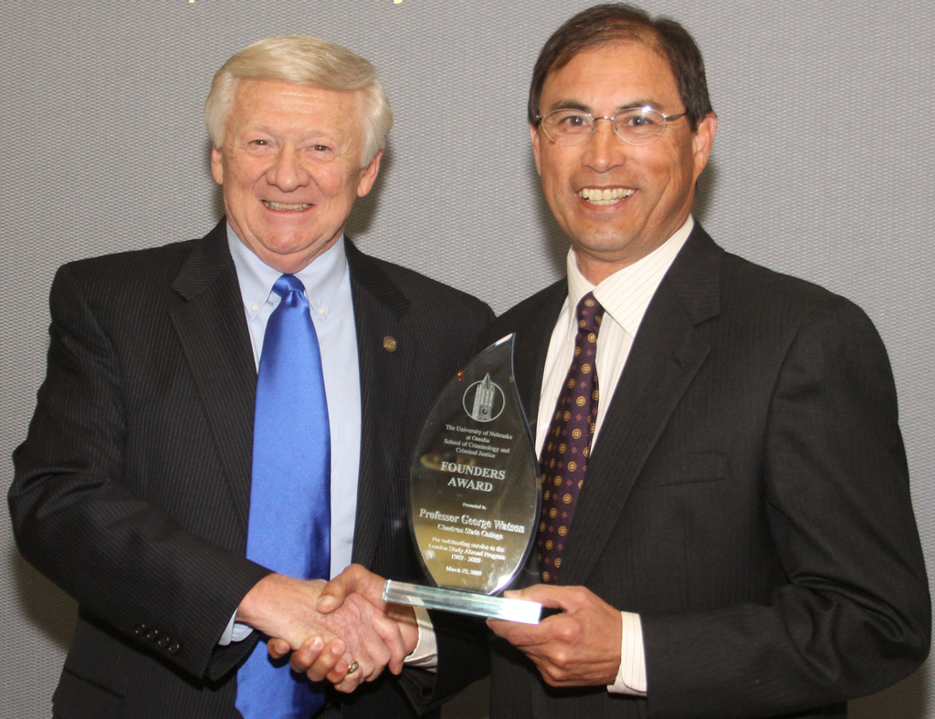 Dr. George Watson, at right, receives the Founder's Award from Dr. Bill Wakefield of the University of Nebraska at Omaha.