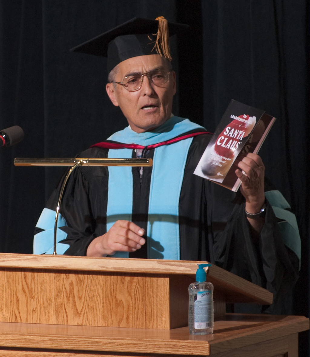 Dr. Clark Gardener displays the book that served as a source for his commencement speech, 