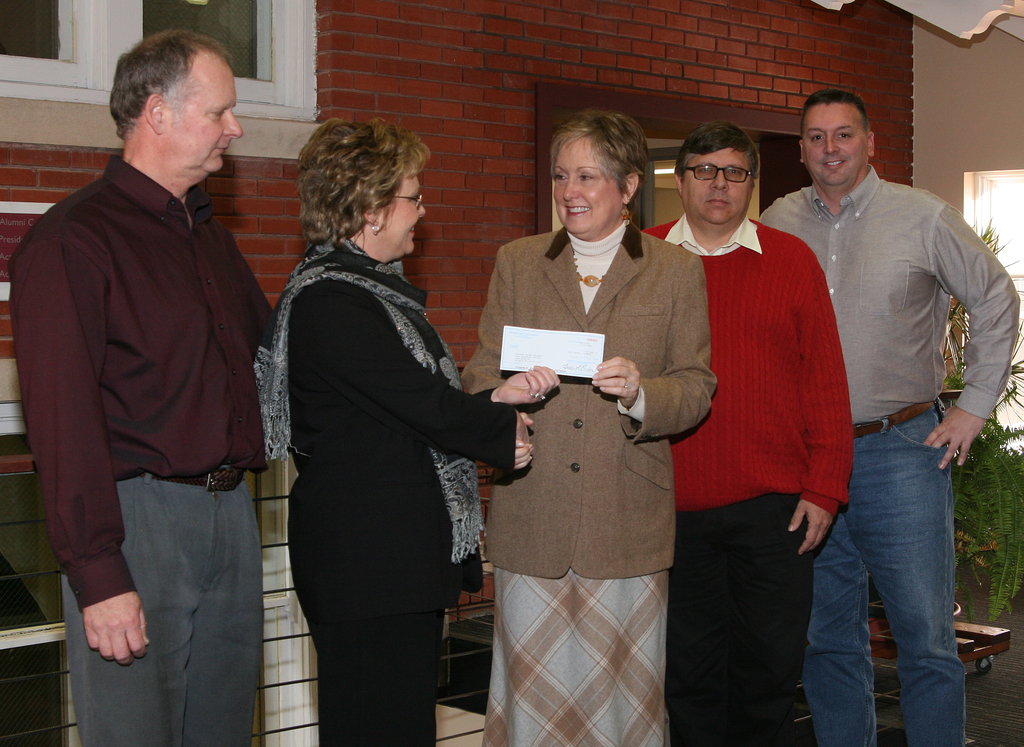 Bryce Landen and Terry Rajewich present the check to CSC representatives Janie Park, Dale Grant and Blair Brennan.