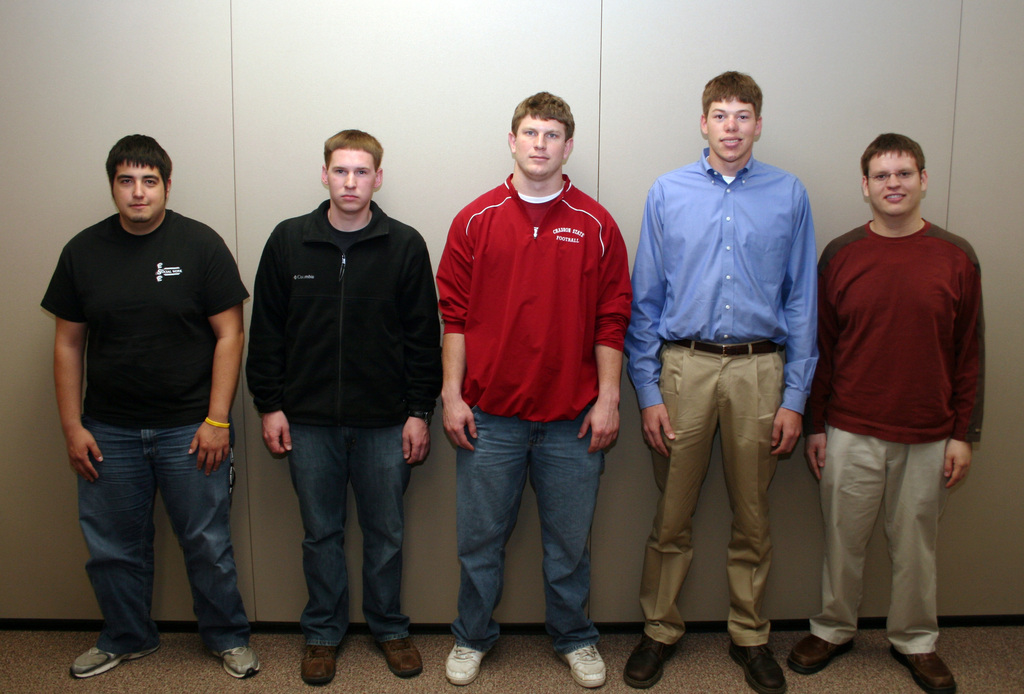 Five young men pose for a photo