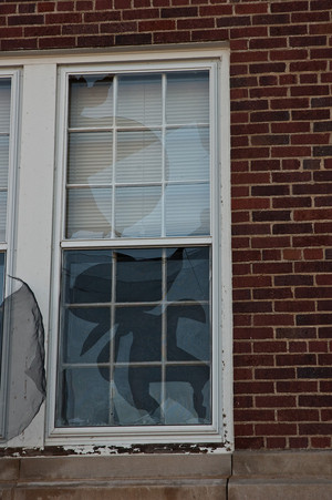 Broken storm windows on the west side of Edna Work Hall