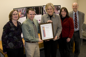 CSC faculty members present the certificate