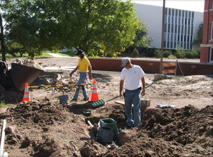 CSC grounds crew work on a sprinkler