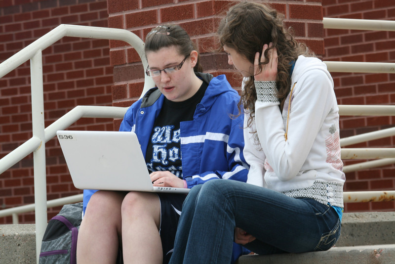 Kendra Vanderbeek, at left, reads a poem she wrote to Dana Slaymaker during the Scholastic Contest at Chadron State College.