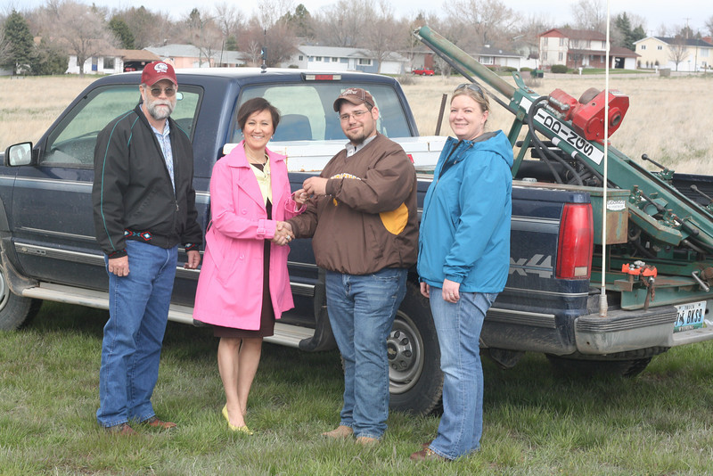 Cyrus Kezar of BKS, second from right, hands over the keys of the soil sampling truck to Karen Pope of the Chadron State Foundation.