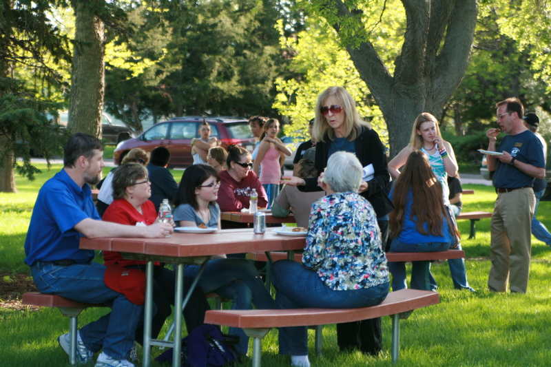 Maggie Smith-Bruehlman, standing, talks to attendees of Upward Bound's picnic.