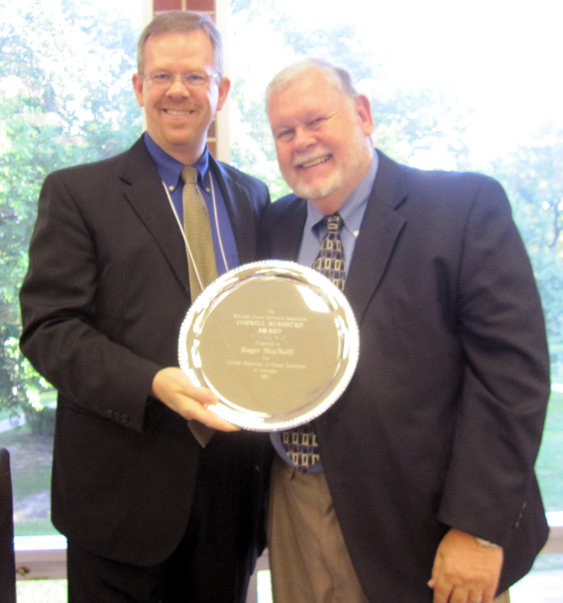 Roger MacNeill receives the Runestad Award from Phil Hesterman.