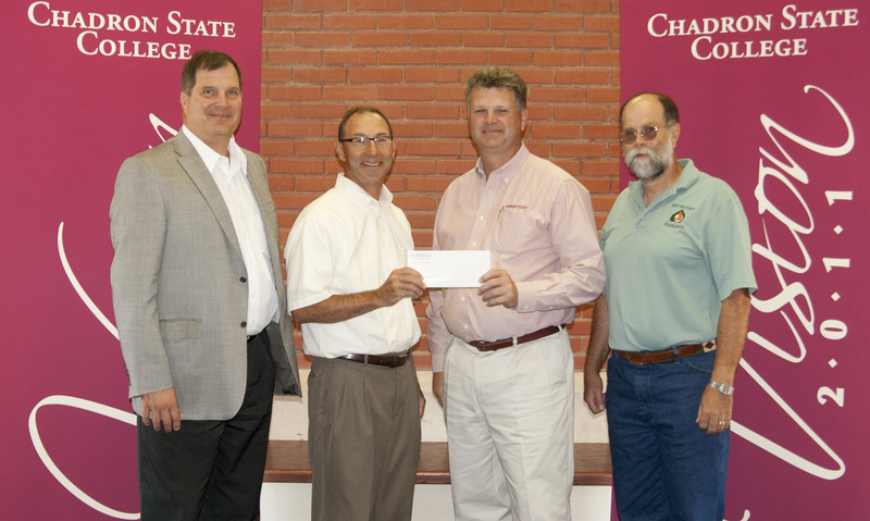 WESTCO President David Briggs, second from right, presents the $100,000 check to Randy Bauer.