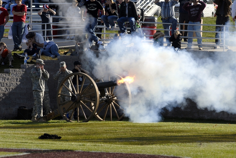 The replica six-pound Napoleon cannon fires during a Chadron State College football game.