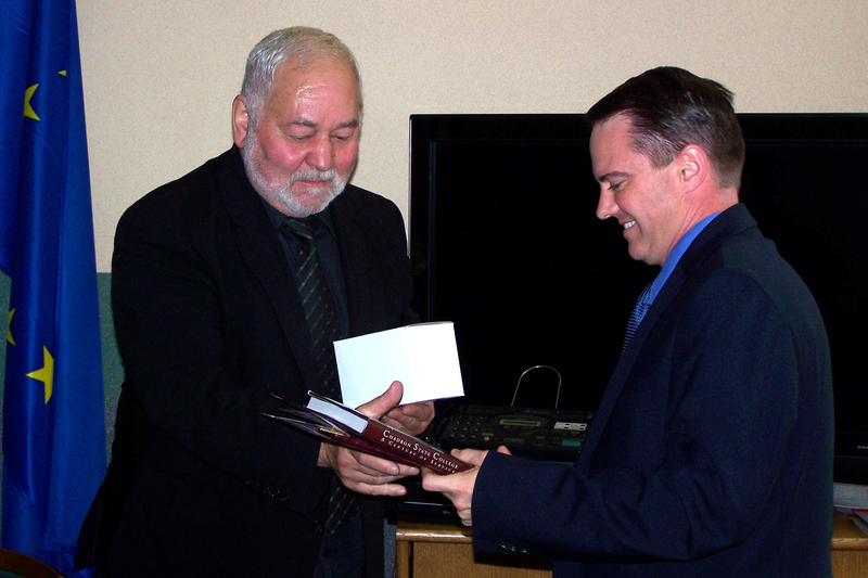 Dr. Joel Hyer, Chadron State College presents gifts to Jan Chajda, rector of the President Stanislaw Wojciechowski Higher Vocational State School at Kalisz, Poland.